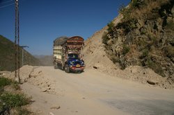 Truck carrying supplies negotiates a cleared landslide