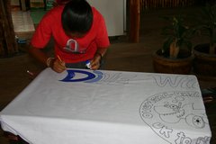 Ita beginning the painting of the banner