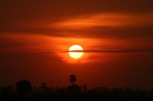 The sun sets red over the Killing Fields