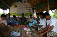 The fishermen talking to Anchalee about rebuilding their fishing business