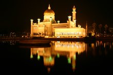 Reflections of the mosque lit up at night