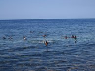 Children frolic in the clear blue sea