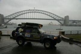 Car in front of Opera House and Harbour Bridge